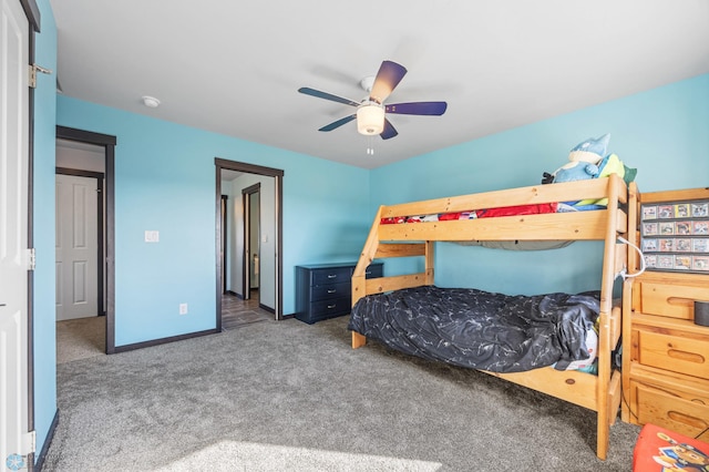 carpeted bedroom with ceiling fan and baseboards