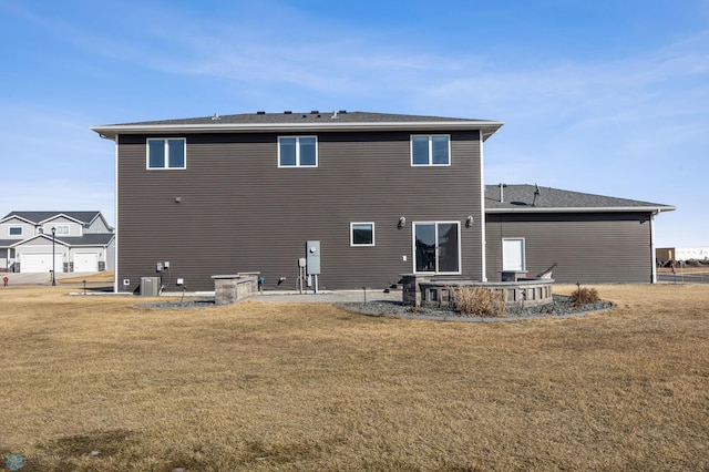 back of property with a patio area and a lawn