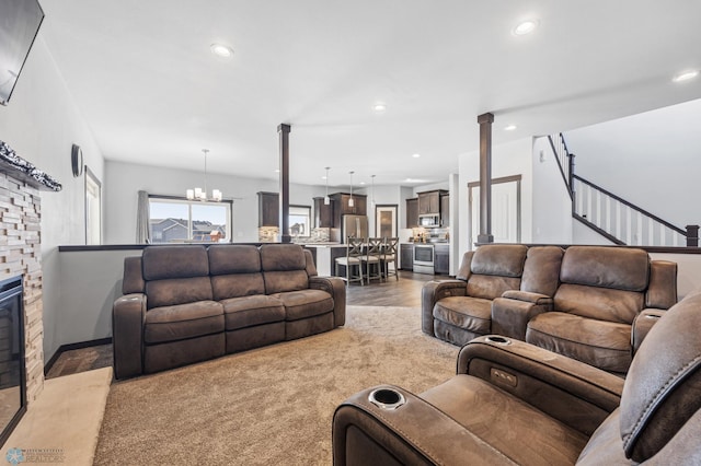 530 Piper St, Kindred, ND 58051 - living area featuring recessed lighting, a chandelier, light wood-style flooring, and a stone fireplace