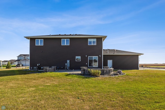530 Piper St, Kindred, ND 58051 - back of house featuring a lawn, central air condition unit, and a patio area