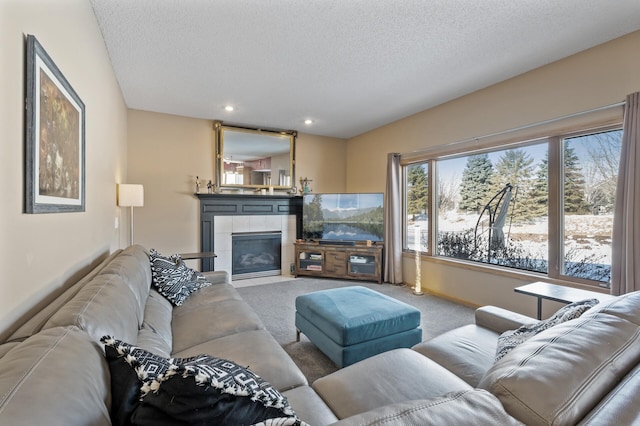 carpeted living room featuring a textured ceiling, a tile fireplace, and recessed lighting