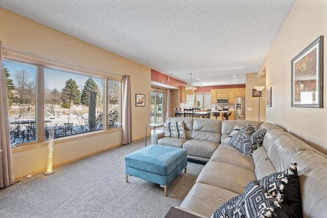 living area featuring baseboards, a textured ceiling, and light colored carpet