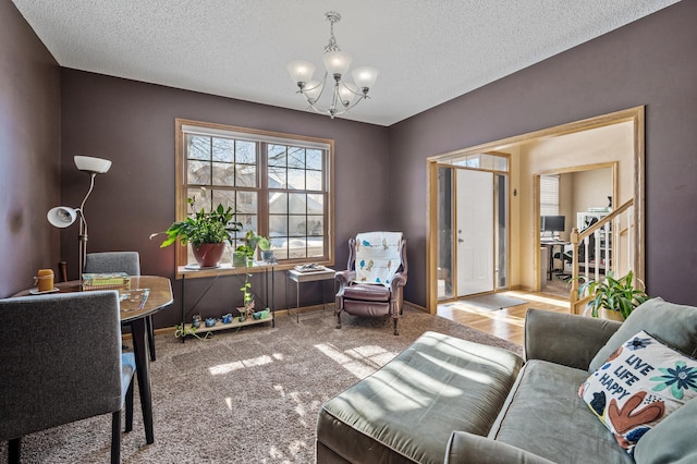 interior space with a notable chandelier, a textured ceiling, baseboards, and stairs