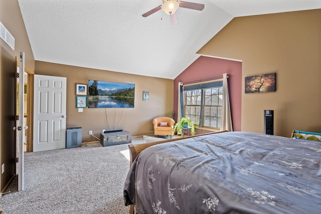 carpeted bedroom featuring lofted ceiling, visible vents, ceiling fan, and a textured ceiling