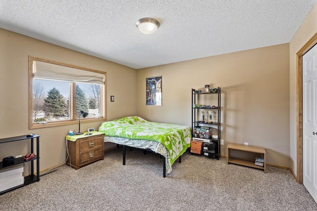 carpeted bedroom with a textured ceiling and baseboards