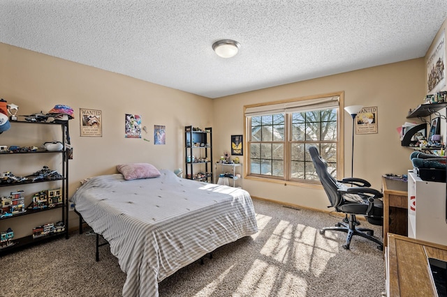 bedroom with carpet floors, visible vents, a textured ceiling, and baseboards