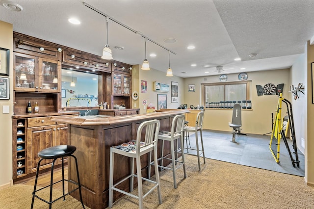 bar featuring a textured ceiling, indoor wet bar, a ceiling fan, and recessed lighting