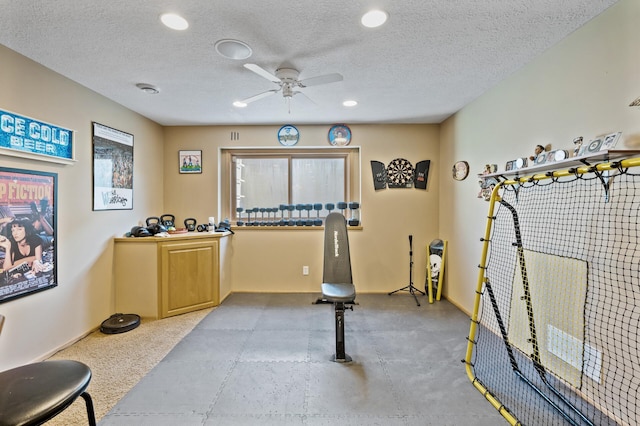 workout room with recessed lighting, ceiling fan, and a textured ceiling