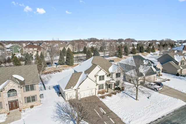 snowy aerial view with a residential view