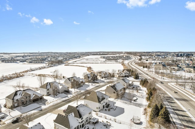 snowy aerial view with a residential view