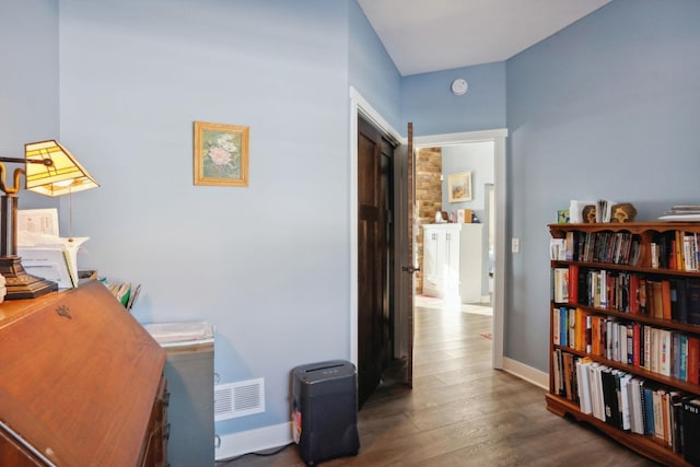 office with visible vents, baseboards, and wood finished floors