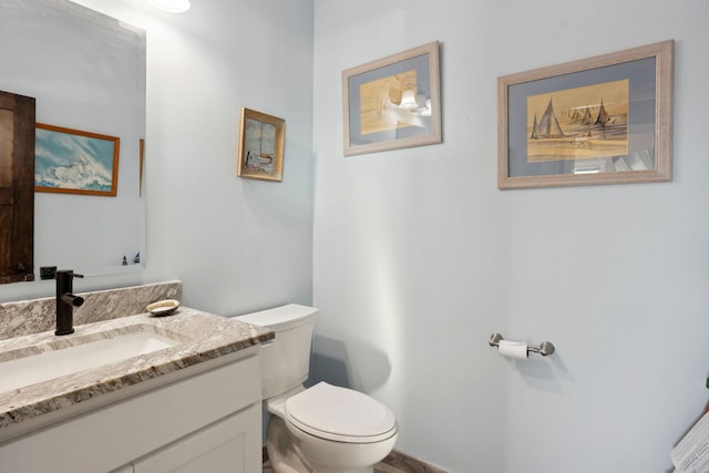 bathroom featuring toilet and vanity