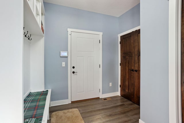 entrance foyer featuring baseboards and wood finished floors