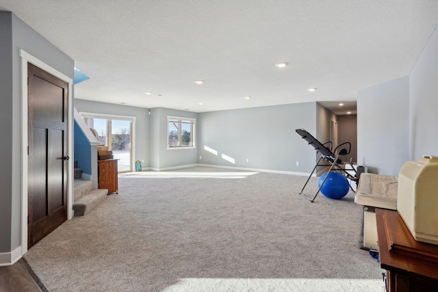 workout room with carpet floors, recessed lighting, a textured ceiling, and baseboards