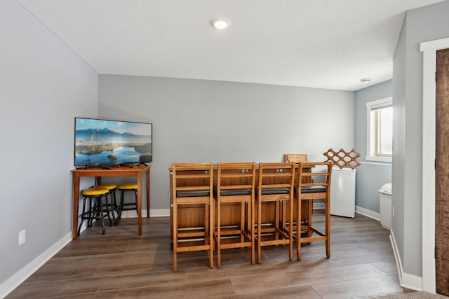 dining area featuring wood finished floors and baseboards