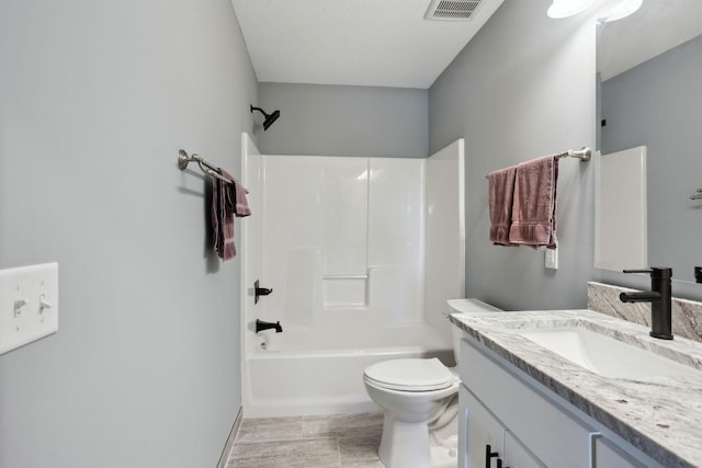 bathroom with toilet, visible vents, shower / washtub combination, and vanity