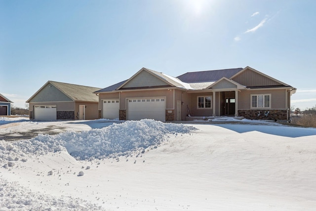 craftsman-style house featuring an attached garage and stone siding