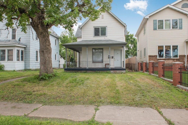 view of front of home featuring covered porch, fence, and a front yard