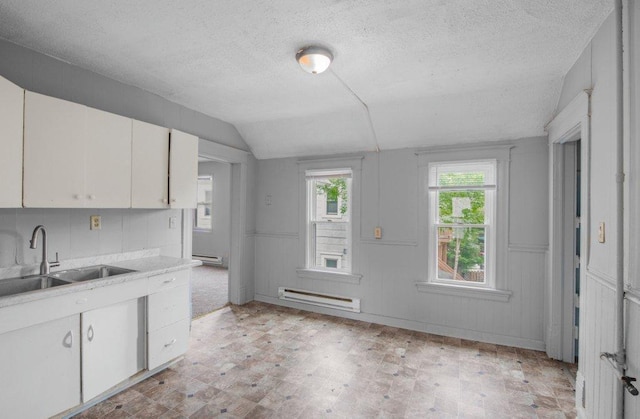 kitchen featuring white cabinets, light countertops, a sink, and light floors