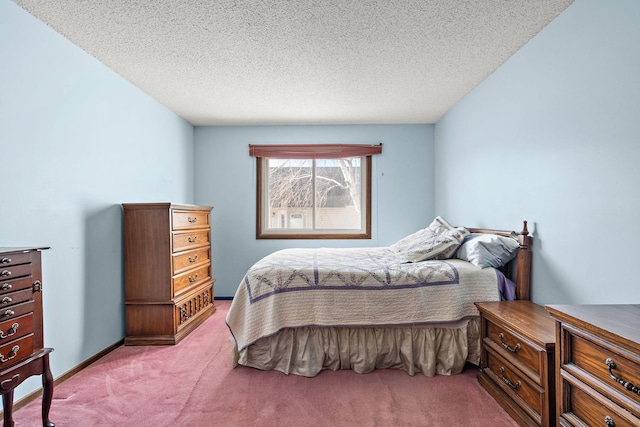 carpeted bedroom featuring a textured ceiling and baseboards