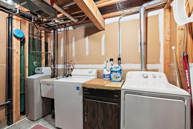 clothes washing area with laundry area and independent washer and dryer