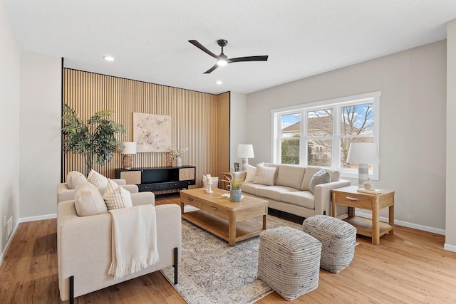 living area featuring ceiling fan, recessed lighting, wood finished floors, and baseboards