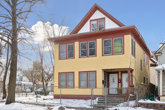 view of front of home featuring a fenced front yard and stucco siding