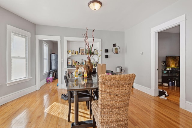 dining room with baseboards and wood finished floors