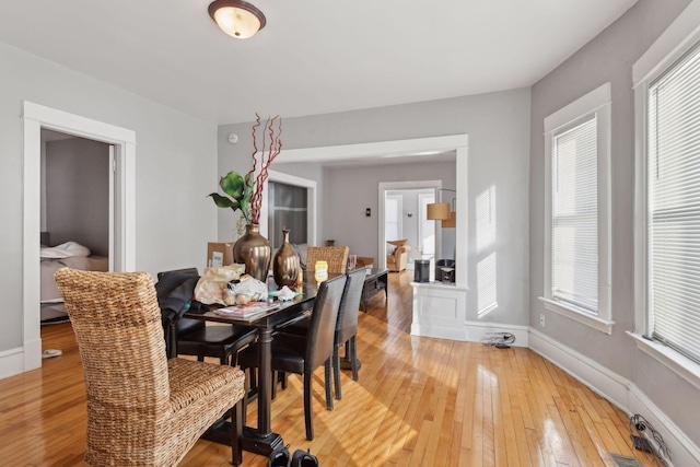 dining area with a healthy amount of sunlight, wood finished floors, and baseboards