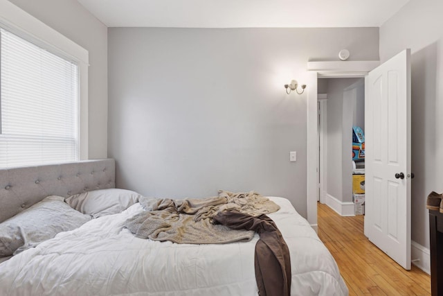 bedroom featuring baseboards and wood finished floors