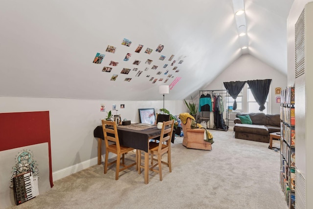 carpeted office space featuring lofted ceiling and baseboards