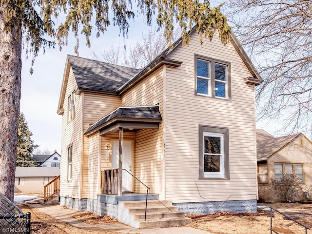 view of front facade featuring roof with shingles