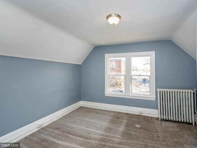 bonus room with lofted ceiling, radiator heating unit, carpet flooring, and baseboards