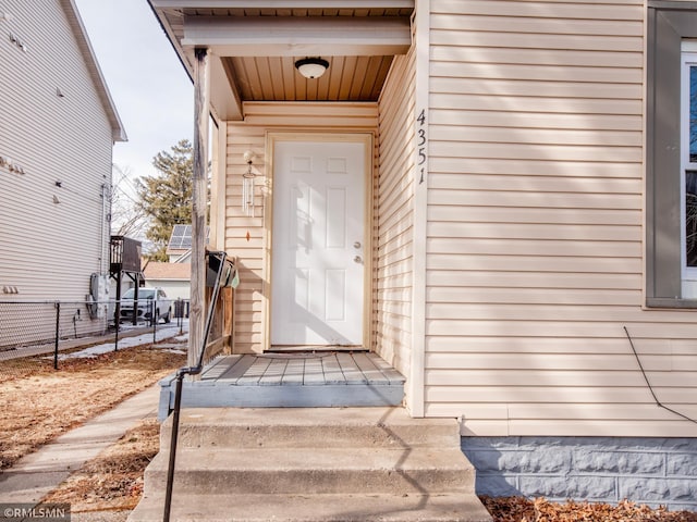 view of exterior entry with fence