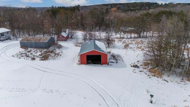 snowy aerial view with a forest view