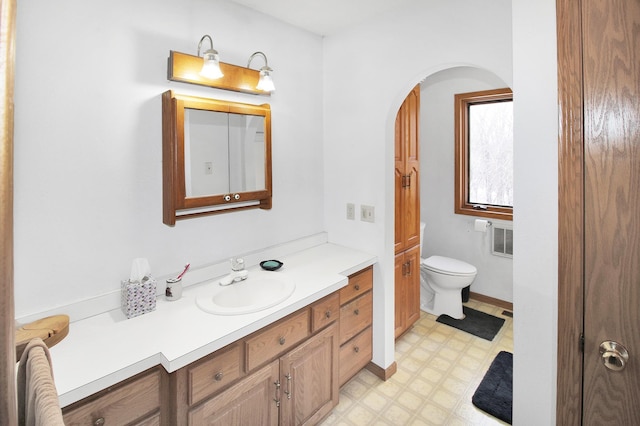 bathroom featuring baseboards, vanity, toilet, and tile patterned floors