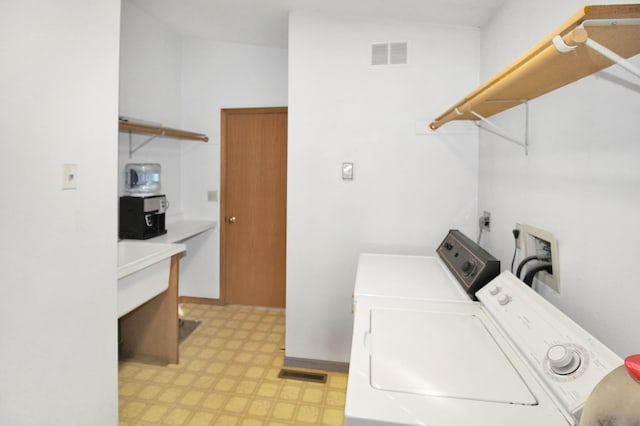 washroom featuring laundry area, visible vents, light floors, and washer and dryer