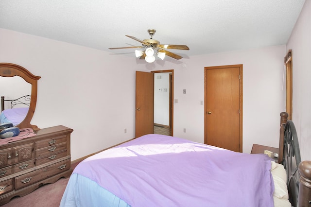 bedroom with a textured ceiling, a ceiling fan, and light colored carpet