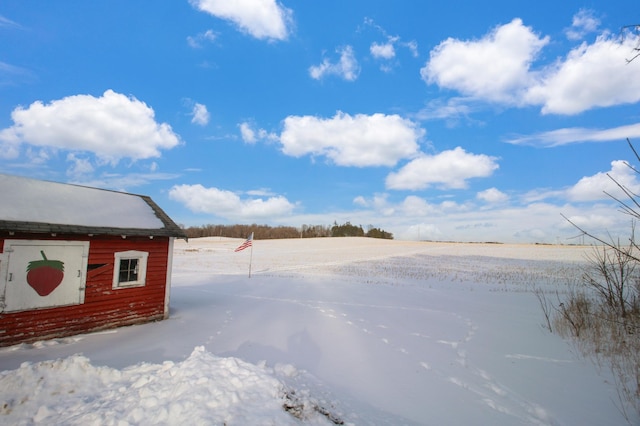 yard layered in snow with an outdoor structure