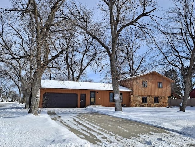 view of front of house featuring stone siding and an attached garage