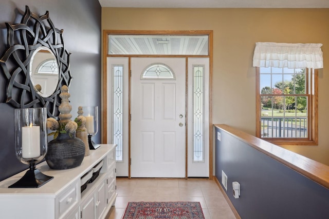 foyer entrance with baseboards, visible vents, and light tile patterned flooring