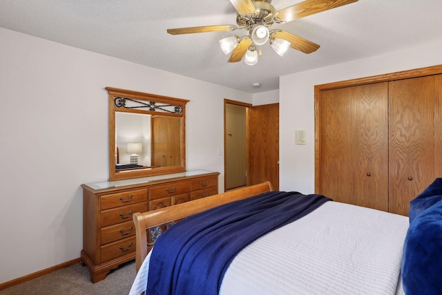 bedroom with carpet floors, a closet, a ceiling fan, a textured ceiling, and baseboards