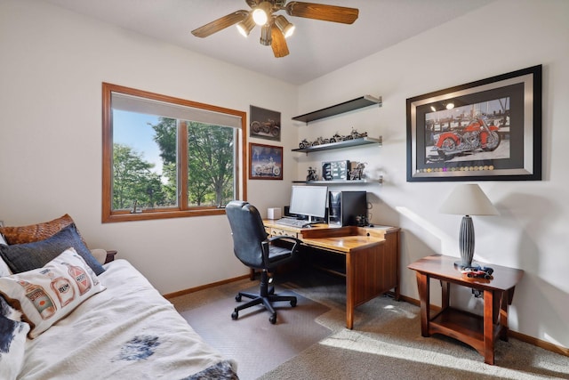 carpeted home office featuring baseboards and a ceiling fan