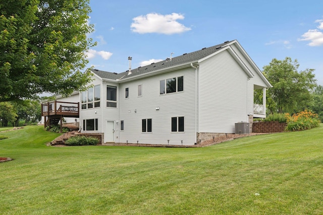 back of house with central AC, a lawn, and a wooden deck