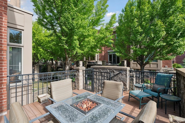 deck with an outdoor fire pit and outdoor dining area