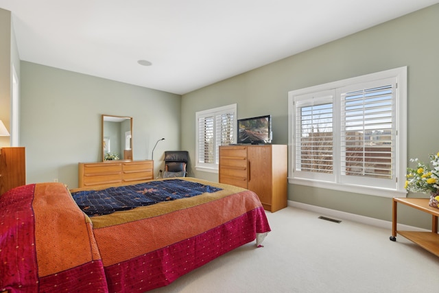 carpeted bedroom with visible vents and baseboards