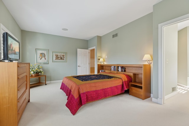 bedroom with baseboards, visible vents, and light colored carpet