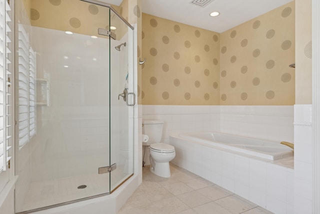 full bathroom with a bath, a shower stall, toilet, and wallpapered walls