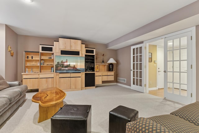 living room featuring light carpet, visible vents, baseboards, french doors, and baseboard heating