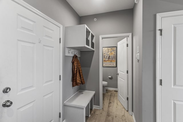 mudroom with light wood finished floors and baseboards